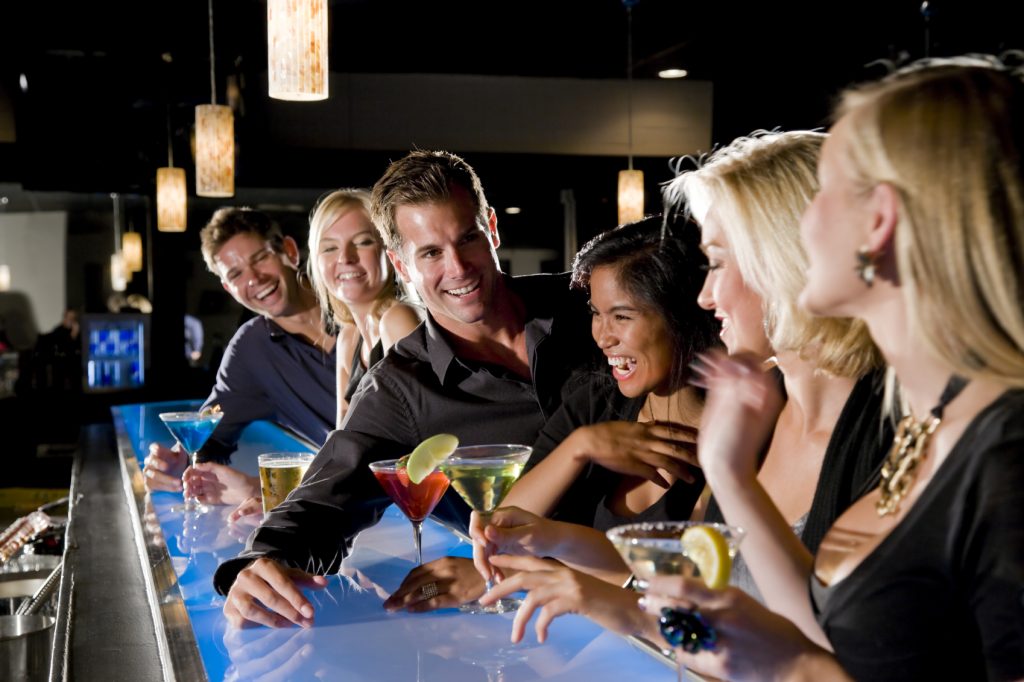 Group of people with drinks at nightclub bar