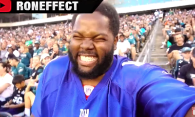 fan wears giants jersey to eagles practice